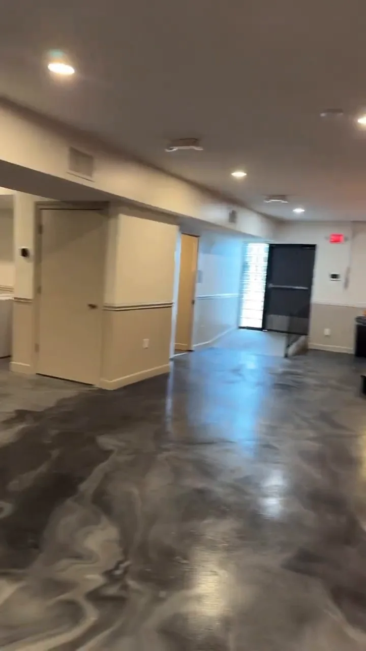 Event space hallway with gray metallic epoxy floor